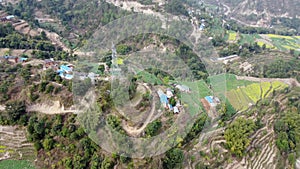 An aerial view of the terraced fields on a hillside farming community in Nepal