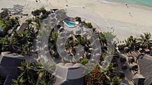 Aerial view of Thatched roof of beach umbrellas of luxury ocean view resort at the beautiful white sand ocean coast in