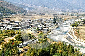 Aerial view of Thimphu City with Bhutanese traditional style houses near a river in Paro, Bhutan