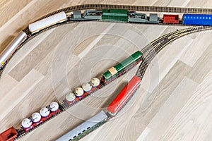 Aerial view on three model trains on wooden floor