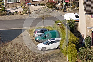 Aerial view of three parked cars in a street