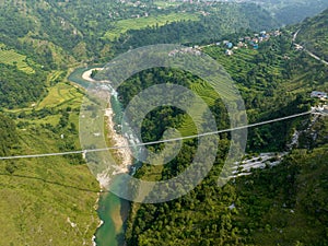 Aerial view of a Tibetan suspended bridge in Nepal. Wild nature