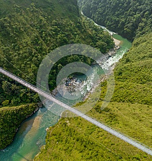 Aerial view of a Tibetan suspended bridge in Nepal. Wild nature