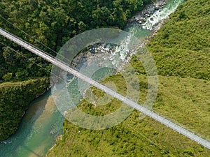 Aerial view of a Tibetan suspended bridge in Nepal. Wild nature