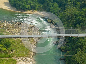 Aerial view of a Tibetan suspended bridge in Nepal. Wild nature