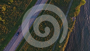 Aerial view to cliff, sea and car driving on road