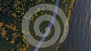 Aerial view to cliff, sea and car driving on road