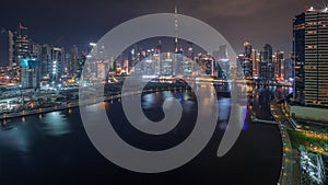 Aerial view to Dubai Business Bay and Downtown with the various skyscrapers and towers all night timelapse