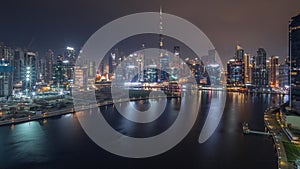 Aerial view to Dubai Business Bay and Downtown with the various skyscrapers and towers all night timelapse