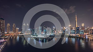 Aerial view to Dubai Business Bay and Downtown with the various skyscrapers and towers night timelapse