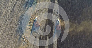 Aerial view to field with two plowing agriculture machines