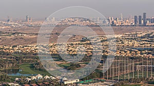 Aerial view to Golf course with green lawn and lakes, villa houses behind it timelapse.