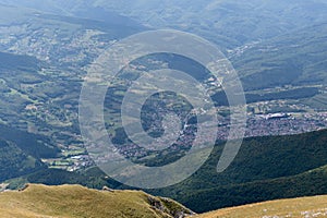 Aerial view to hilly countryside with settlement