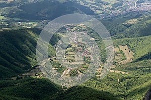 Aerial view to hilly countryside with settlement