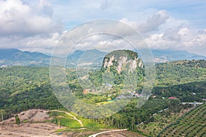 Aerial view to the Limestone hill  Bukit Batu Kapur at Cinta Manis, Pahang, Malaysia. A mountain rock out of nowhere in the middle