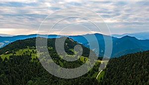 Aerial view to Mala Fatra mountains in Slovakia. Sunrise above mountain peaks and hills in far. Beautiful nature, vibrant colors.