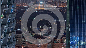 Aerial view to neighborhood Deira and Dubai creek with typical old and modern buildings night timelapse.