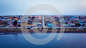 Aerial View to the Porvenir city under the Sunset Lights