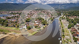 Aerial view to river Pereque-Acu in historic town Paraty with green mountains covered with white clouds in background, Unesco