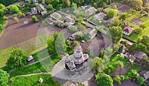 Aerial view to the small provincial town in Ukraine with beautiful wooden church and residential area