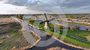 Aerial View to the wooden windmills at sunset in the Netherlands village of Kinderdijk.