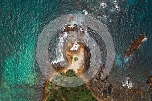 Aerial view Top down seashore big wave crashing on rock cliff Beautiful dark sea surface in sunny day summer background