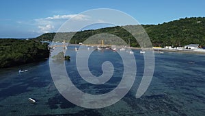 The aerial view from the top of the iconic yellow bridge on the island of Nusa Lembongan. Expanse of seaweed fields can be seen