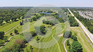 Aerial View from the top n of the golf course. People and cars on a golf course from a height.