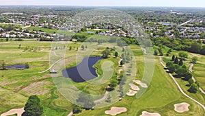 Aerial View from the top n of the golf course. People and cars on a golf course from a height.