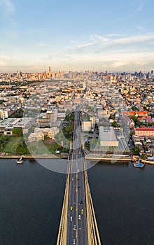 Aerial view of top of Rama 8 Bridge and Chao Phraya River in structure of suspension architecture concept, Urban city, Bangkok