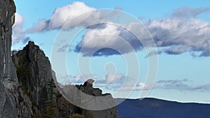 Aerial view of the top of a rocky mountain on a background of clouds