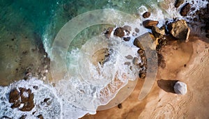 Aerial view top seashore, rocky coast, waves crashing on rock cliff. Blue ocean surface sunny summer