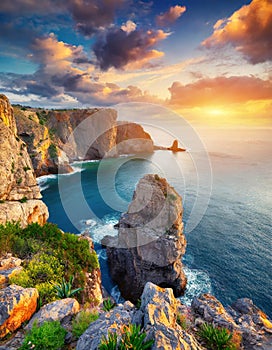 Aerial view top seashore, rocky coast, waves crashing on rock cliff. Blue ocean surface sunny summer