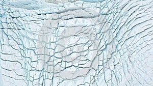 Aerial view: Top View Glacier Ice Flow Texture Vibrant Blue. Climate Change and Global Warming. Arctic nature ice landscape