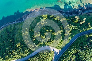 Aerial view top view seashore with asphalt road curve in Tropical island Amazing nature view Beautiful island in Phuket Thailand