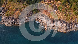 Aerial view. Top view of turquoise sea water washes the rocky shore. Landscape background.