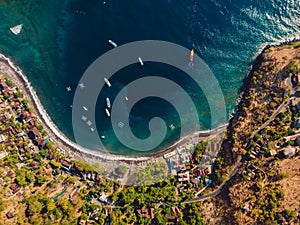 Aerial view of tourist town with blue sea water and boats, drone shot. Amed, Bali