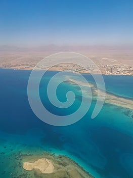 Aerial view of the touristic city of Hurghada from Egypt and the vibrant colors of the Red Sea.