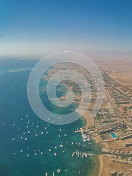 Aerial view of the touristic city of Hurghada from Egypt and the vibrant colors of the Red Sea.