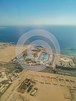 Aerial view of the touristic city of Hurghada from Egypt and the vibrant colors of the Red Sea.