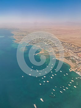 Aerial view of the touristic city of Hurghada from Egypt and the vibrant colors of the Red Sea.