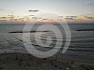 Aerial view of tourists on the beach of Tel Aviv,  Israel during sunset