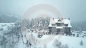 Aerial view of tourists and mountain chalet by the Morskie Oko or Sea Eye lake in southern Poland