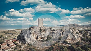 Aerial view of tower castle and medieval town with valley and sea - Posada, Sardinia