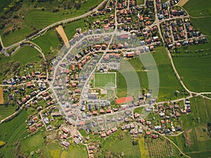 Aerial view of town and green soccer stadium