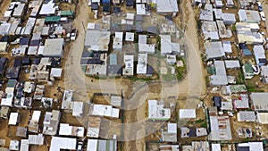 Aerial view, township and shack buildings in South Africa, Gugulethu or neighborhood outdoor. Drone, slums and area