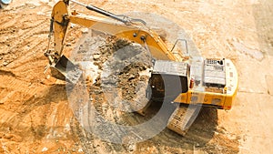 Aerial view of Tracked excavator starts digging ground preparing to build condominium. track hoe working.