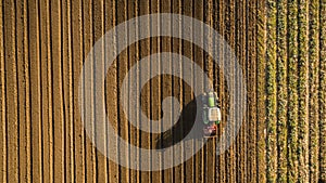 Aerial view of tractor cultivating and harrowing field