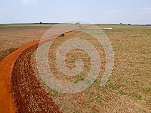 Aerial view of a tractor harrowing the soil to plant soybeans