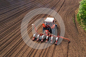 Aerial view of tractor with mounted seeder performing direct seeding